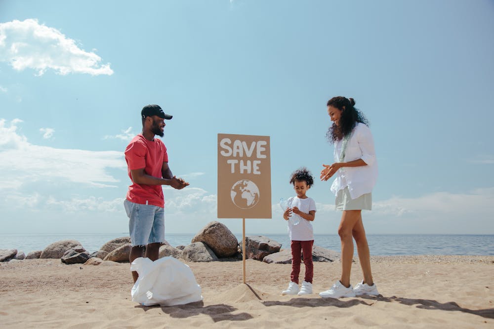 A family on the beach with a "Save the Earth" placard